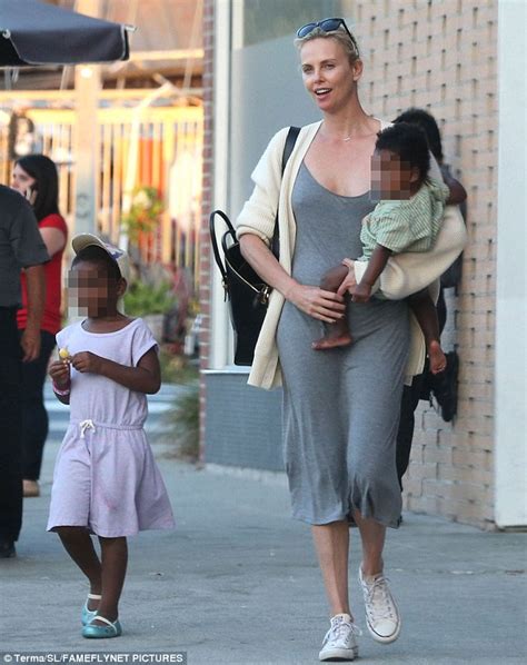 Charlize Theron puts Adopted son in Dressess and wigs ...