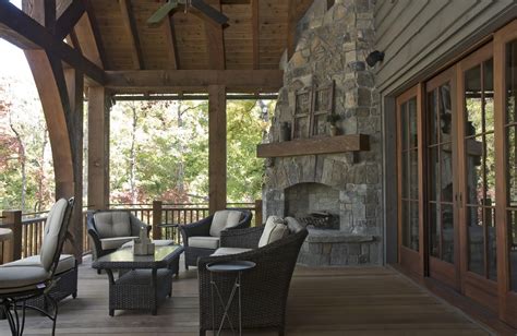 corner outdoor fireplace Porch Rustic with ceiling fan ...